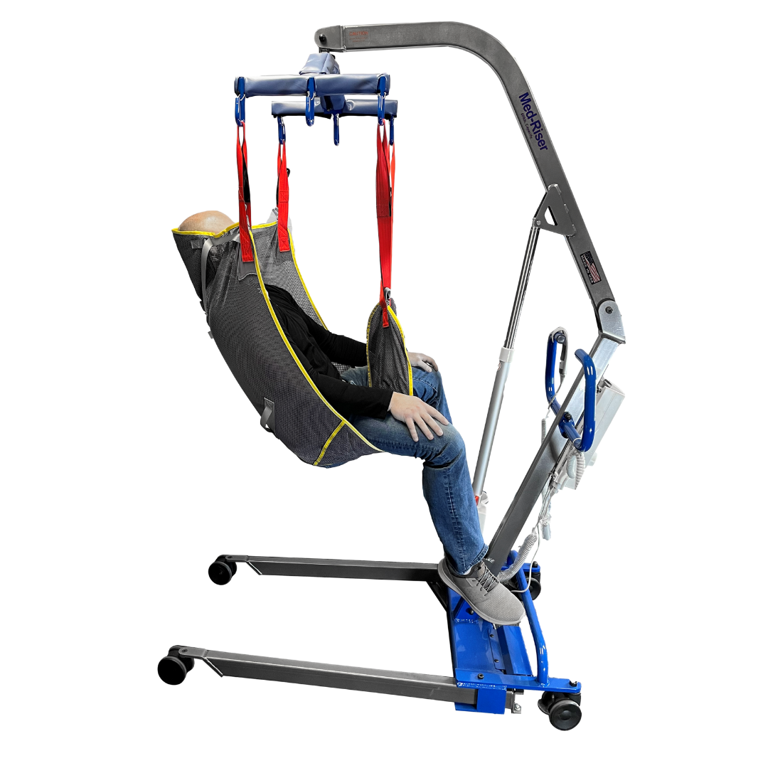 A person is seated in a gray sling attached to the blue and gray Med-Mizer MedRiser 600 Patient Lift, which has wheels and red straps for secure and safe patient handling during transfers.
